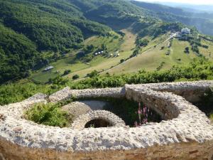 a stone wall with a view of a mountain at HOTEL Pyramid Lodge in Visoko