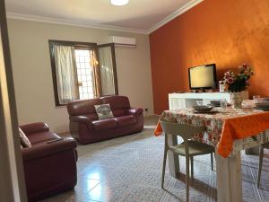 a living room with a table and a couch at Casa Grace in Mazara del Vallo