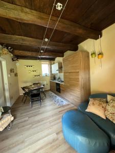 a living room with a blue couch and a table at Luna Home in Arona