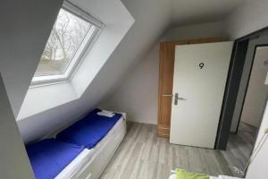 a small attic room with a bed and a window at Monteurzimmer an der Schlei in Rabenkirchen-Faulück +60 photos