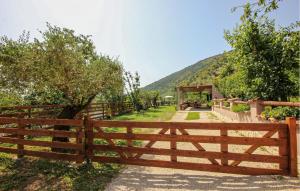 a wooden fence with a mountain in the background at Lovely Home In Avella in Avella +19 photos