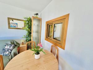 a dining room with a wooden table and a mirror at T252 - Atrium Beach 2 - 2004 Finestrat in Cala de Finestrat