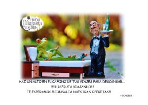 a statue of a man holding a plate with a frog at Hospedium Hotel Doña Mafalda de Castilla in Plasencia