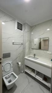 a white bathroom with a sink and a toilet at THE DECK OTEL in Trabzon +46 photos