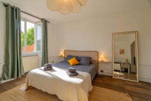 a bedroom with a bed and a large mirror at Les Suites de Bellac in Bellac