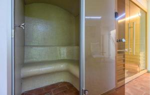 a shower with a glass door in a bathroom at Cozy Apartment In Montemonaco in Montemonaco