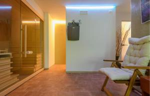a hallway with a chair and a walk in closet at Cozy Apartment In Montemonaco in Montemonaco +22 photos
