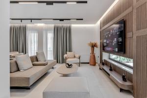 a living room with a couch and a flat screen tv at PREVEZA VILLA center in Preveza