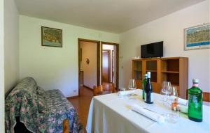 a room with a table with wine bottles and glasses at Cozy Apartment In Montemonaco in Montemonaco
