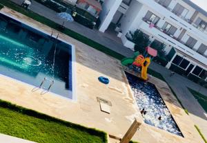 an overhead view of a swimming pool with a playground at Elegant & spacious with a view in Mansouria