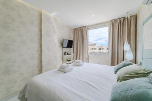 a bedroom with a large white bed and a window at Poolside Escape - airco & heated pool in Adeje +47 photos