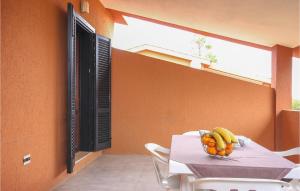 a table with a bowl of bananas on it at Awesome Apartment In Costa Rei -Ca- With Wifi in Monte Nai