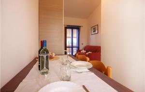 a table with a bottle of wine and glasses on it at Awesome Apartment In Costa Rei -Ca- With Wifi in Monte Nai
