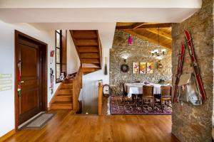 a dining room with a table and a stone wall at Stone Villa Retreat with Private Pool in Arachova in Arachova