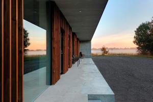 a row of benches sitting on the side of a building at Hotel Vibe In Architectural Settings in Årre