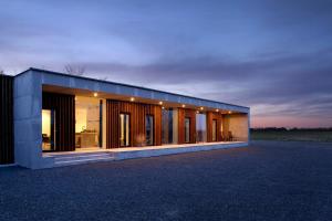 a building with a lot of windows on a field at Hotel Vibe In Architectural Settings in Årre