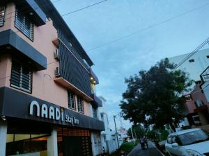 坦贾武尔Naadi Hotel New Busstand Thanjavur的侧面有标志的建筑物