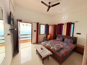 a bedroom with a bed and a ceiling fan at Rameshwari Homestay in Lansdowne
