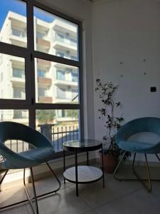 a room with two chairs and a table and a window at Apartments Perezaj II in Ulcinj