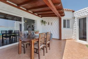 a dining room with a table and chairs on a patio at Casa Betta in Costa Calma