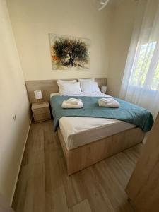 a bedroom with a bed with two towels on it at Two little olives Studio apartment in Kissamos +51 photos
