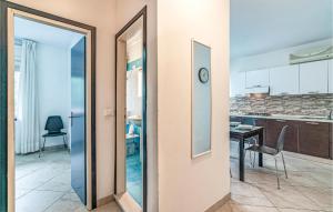 a kitchen and a dining room with a table at La Piazzetta in Rosolina Mare +10 photos