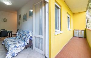a room with a chair and an open door at La Piazzetta in Rosolina Mare