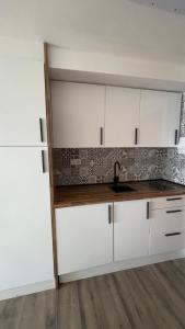 a kitchen with white cabinets and a sink at Sky&Beach Apartments in Aguadulce