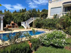 a house with a swimming pool in a yard at La Perla Montaña Tanger in Tangier