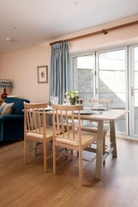 a dining room with a table and two chairs at Windy Cottage, Coldstream in Coldstream