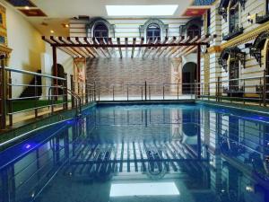 a swimming pool in a building with water in it at RAJWADA RESORT & HOTEL in Raipur