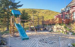 a playground with a slide in front of a house at Nice Apartment In Sandnes With Wifi in Sandnes +7 photos