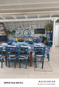 a table and chairs with a blue table at Annyhouse via litoranea 38 in Torre del Greco