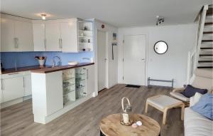 a kitchen and living room with a table and a counter at Beautiful Apartment In Uggdal With House Sea View in Uggdal