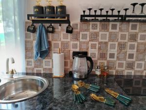 a kitchen counter top with a sink and a counter sidx sidx sidx at Сказочный Дилижан in Dilijan +33 photos