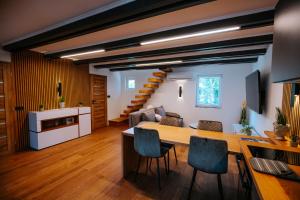 a kitchen and living room with a table and chairs at Poseidon in Pilismarót