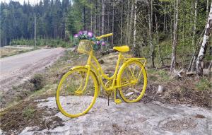 a yellow bike parked on the side of a road at 3 Bedroom Awesome Home In Marnardal in Marnardal