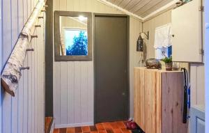 a room with a door and a window and a refrigerator at 3 Bedroom Awesome Home In Marnardal in Marnardal