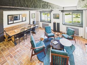 a room with chairs and tables and a dining room at -TY TAD - Magnifique Chaumiere entierement renovee in Névez