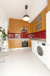 a kitchen with a washer and dryer in it at Baleal Oceanviews in Ferrel