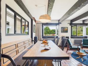a dining room with a wooden table and chairs at -TY TAD - Magnifique Chaumiere entierement renovee in Névez