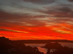 a sunset over a body of water at Apartments Jani in Hvar