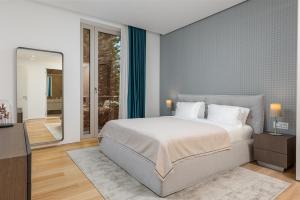 a bedroom with a large bed and a mirror at Dukley Hotel & Resort in Budva
