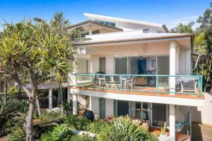 バイロンベイにあるApartment 3 Surfsideのヤシの木が植わる広い白い家