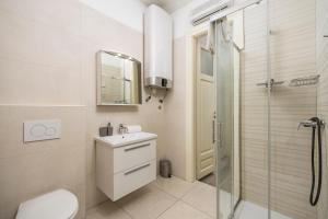 a bathroom with a toilet sink and a shower at Fluminis rooms in Rijeka