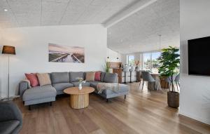 a living room with a couch and a table at Stunning Home In Oksbøl With Sauna in Oksbøl