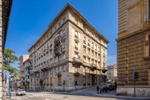 a large stone building on a city street at Fluminis rooms in Rijeka