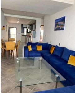 a blue couch with yellow pillows in a living room at Rays View Moulay Bousselham in Moulay Bousselham +15 photos