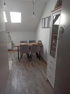 a dining room with a table and two chairs at Agroturystyka u Tadka in Klęczany +11 photos