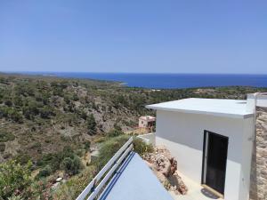 a white house with a view of the ocean at Accommodation in Lithi in Chios